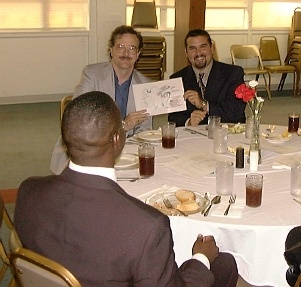 Bill and Randy holding the latest niche theory diagram at the RAM banquet.  Drew is in the foreground.